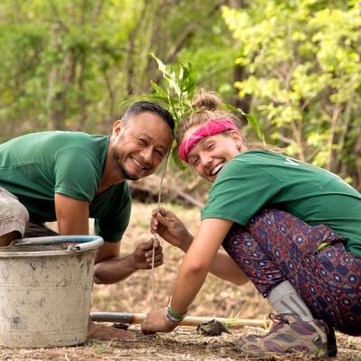 A Projects Abroad staff member and a student plant trees as part of their conservation volunteer work in Costa Rica. A volunteer and staff member work together on a reforestation initiative during Conservation volunteering in Costa Rica.